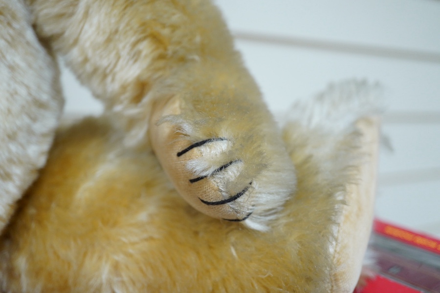 A gold plush mohair teddy bear, perhaps Chad Valley, circa 1950, approx 62cm tall. Condition - fair to good.